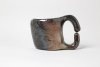 le pinze 2026, 9,5 x 13cm, wood kiln fired/ Holzbrand ~ 1350°C/ 68h, wild clay slip and vulcano ash/ Slipglasur aus wildem Ton und Vulkanasche Frech wie sich hier der wilde Ton in den hohen Temperaturen glänzend glatt und schokobraun über das Objekt schmiegt: Die wunderbare Vulkanasche aus Japan bringt das richtige Finish/ There is something wonderfully cheeky about the way the wild clay, under intense heat, settles into a smooth, lustrous chocolate-brown skin that clings to the vessel. Japanese volcanic ash completes the piece with the perfect finish.SOLD